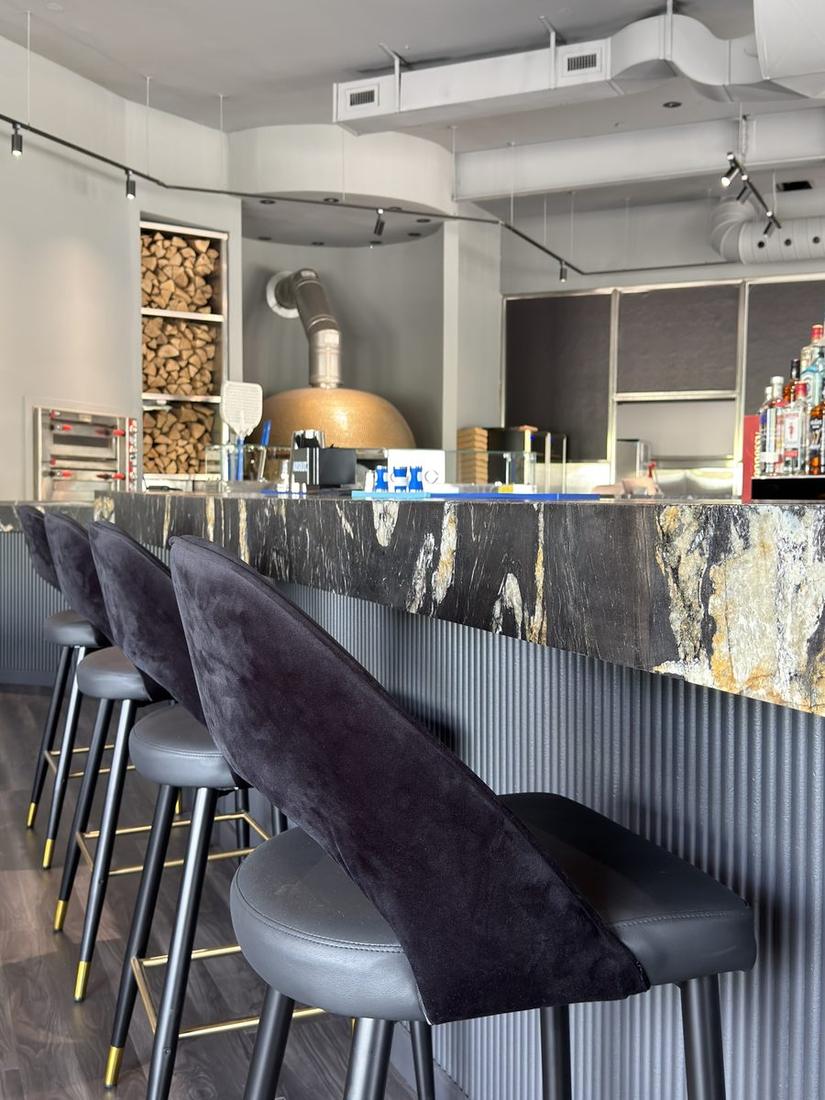 Bar counter with stools and pizza oven