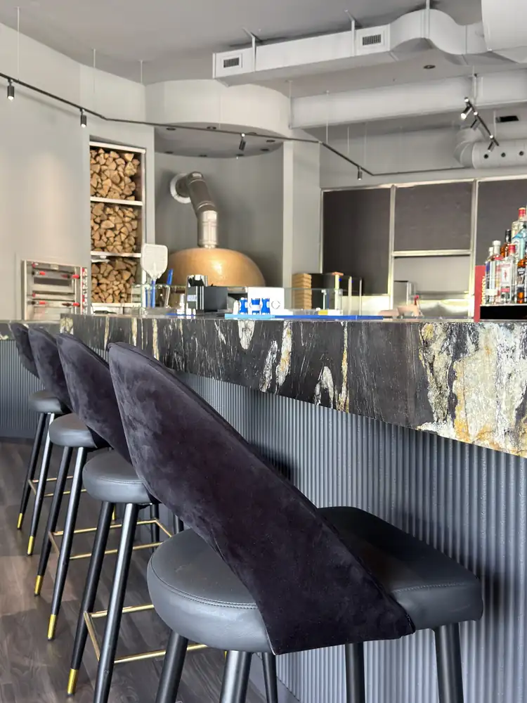 Bar counter with stools and pizza oven